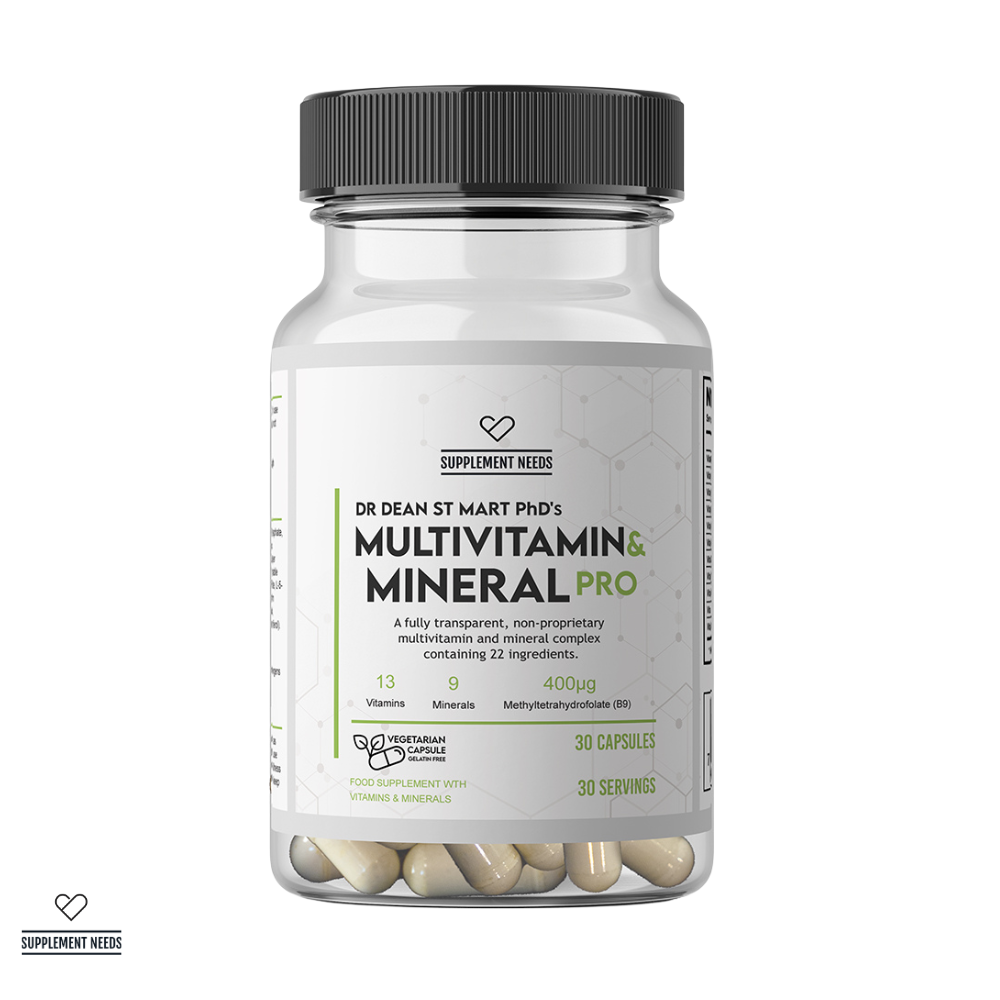 A clear supplement bottle with a black ribbed cap and a white label reading 'Supplement Needs' and 'Dr Dean St Mart Phd's Multivitamin & Mineral Pro' 30 servings. The bottle is shown on a white background with several beige capsules visible through the transparent lower portion.