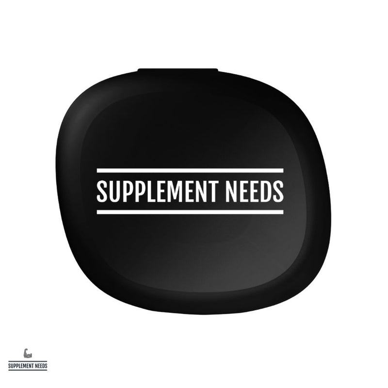 A black plastic pill box with the text 'SUPPLEMENT NEEDS' written on the front.