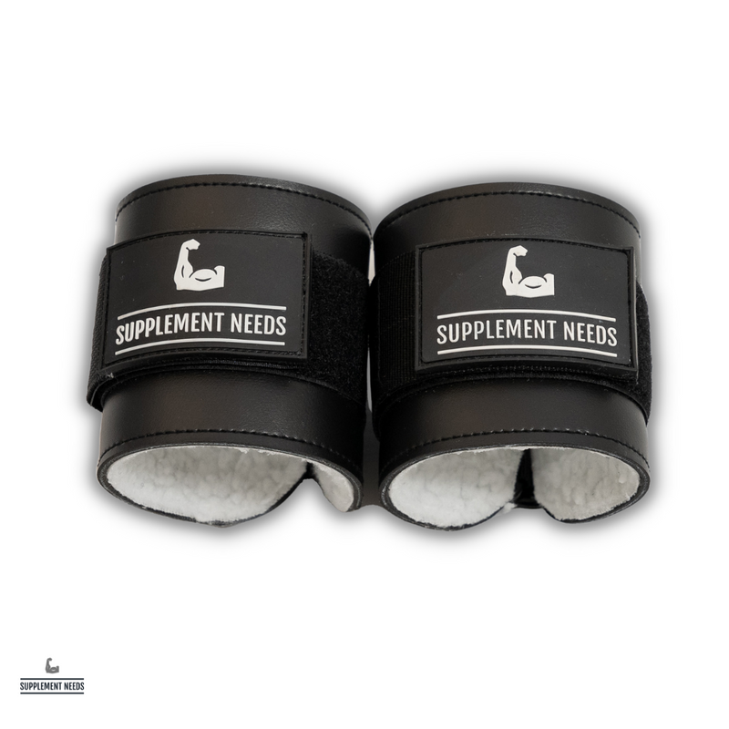 A pair of black Supplement Needs branded Sherpa lined cable cuffs designed for use in resistance training.