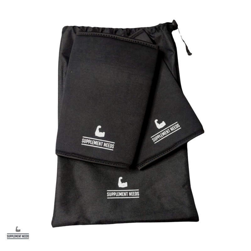 A pair of black neoprene elbow sleeves with subtle silicone branding, displayed in a drawstring bag.